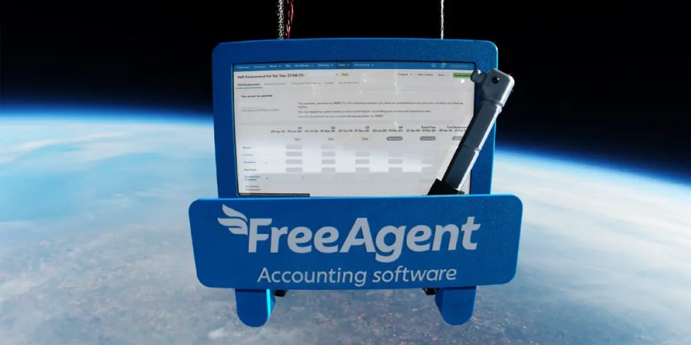A tablet computer with FreeAgent's accounting software hovering above the curve of planet Earth.
