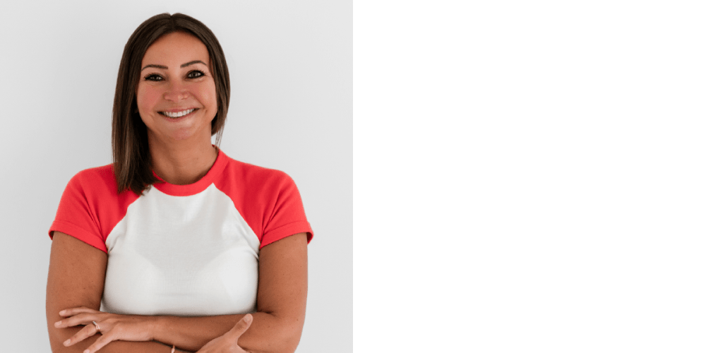 A smiling woman in a red and white t-shirt