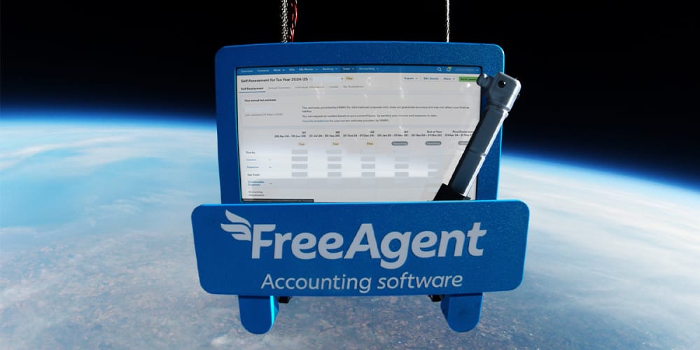 A tablet computer with FreeAgent's accounting software hovering above the curve of planet Earth.