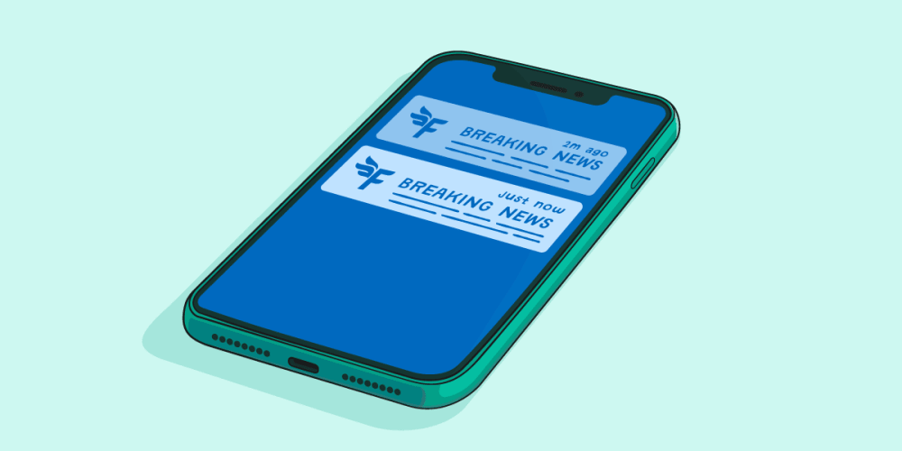 A mobile phone showing a breaking news alert.