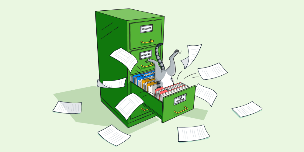A cat jumps into a filing cabinet containing tax return documents.