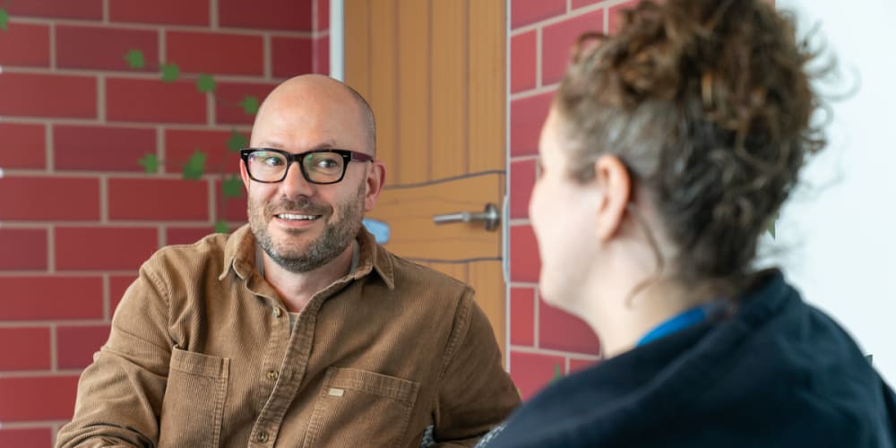 Two people from FreeAgent in conversation in The Den at the FreeAgent offices