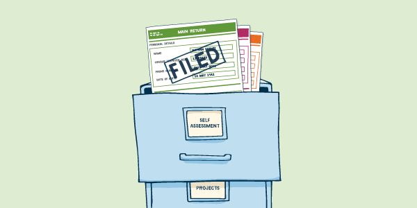 Filing cabinet marked Self Assesssment with completed tax return pages marked filed