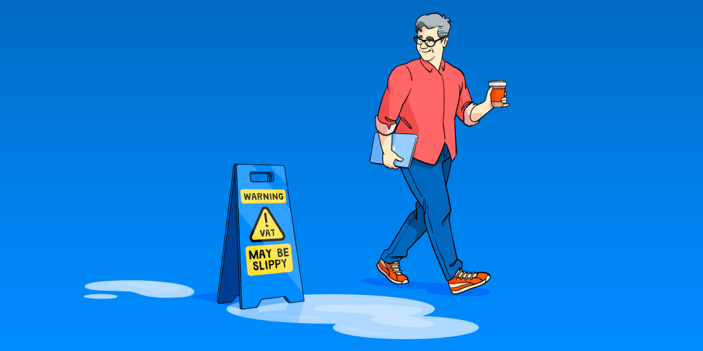 Man avoids a puddle thanks to a sign saying ‘Warning: VAT may be slippy’.