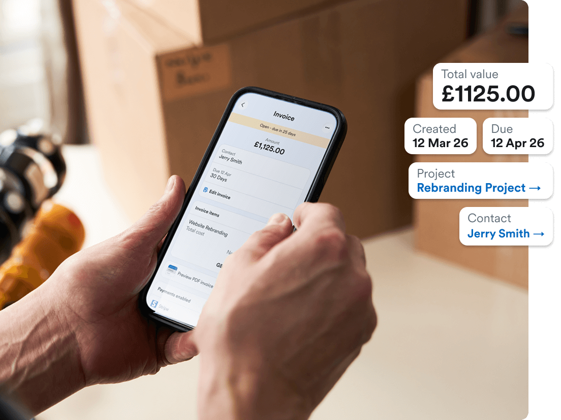 Photo of Zoë Miller from All About The Move creating an invoice on her phone using FreeAgent.