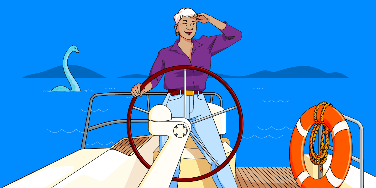 Woman standing confidently at the helm of a boat, holding the wheel and looking out to sea - Nessie, the Loch Ness monster is behind her.