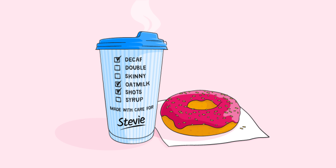 Takeaway coffee cup and pink doughnut